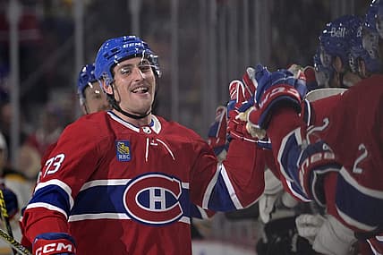 Apr 13, 2023; Montreal, Quebec, CAN; Montreal Canadiens forward Lucas Condotta (73) celebrates with teammates after scoring his first NHL goal during the first period of the game against the Boston Bruins at the Bell Centre. Mandatory Credit: Eric Bolte-USA TODAY Sports