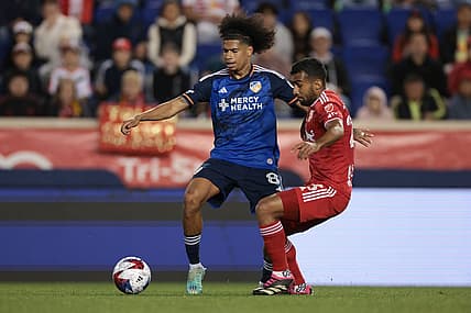May 23, 2023; Harrison, NJ, USA; FC Cincinnati midfielder Marco Angulo (8) battles for the ball against New York Red Bulls midfielder Cristian Casseres Jr (23) during the second half at Red Bull Arena. Mandatory Credit: Vincent Carchietta-USA TODAY Sports