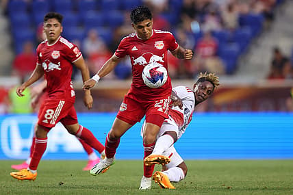 Jul 8, 2023; Harrison, New Jersey, USA; New York Red Bulls midfielder Omir Fernandez (21) battles for the ball against New England Revolution forward Latif Blessing (19) during the first half at Red Bull Arena. Mandatory Credit: Vincent Carchietta-USA TODAY Sports