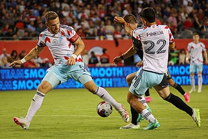 Jul 8, 2023; Chicago, Illinois, USA; Chicago Fire defender Rafael Czichos (5) and defender Mauricio Pineda (22) defend Nashville SC midfielder Alex Muyl (19) during the second half at Soldier Field. Mandatory Credit: Jon Durr-USA TODAY Sports