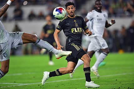 July 8, 2023; Los Angeles, California, USA; Los Angeles FC forward Carlos Vela (10) plays for the ball against San Jose Earthquakes defender Rodrigues (26) during the second half at BMO Stadium. Mandatory Credit: Gary A. Vasquez-USA TODAY Sports