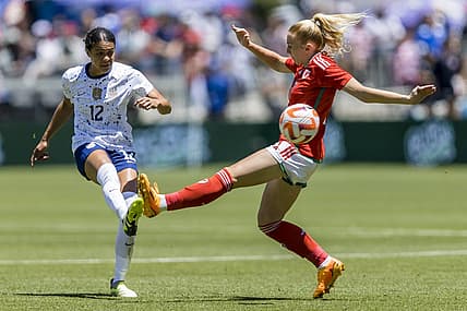 Jul 9, 2023; San Jose, California, USA; United States of America defender Alana Cook (12) passes past Wales midfielder Ceri Holland (7) during the first half at PayPal Park. Mandatory Credit: John Hefti-USA TODAY Sports