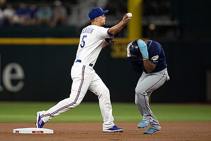 Jul 17, 2023; Arlington, Texas, USA; Texas Rangers shortstop Corey Seager (5) attempts to turn a double play as Tampa Bay Rays shortstop Wander Franco (5) runs to second base in the first inning at Globe Life Field. Mandatory Credit: Tim Heitman-USA TODAY Sports