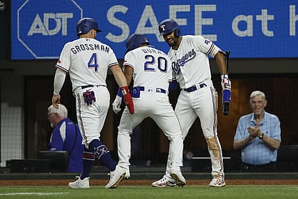 Jul 17, 2023; Arlington, Texas, USA; Texas Rangers left fielder Ezequiel Duran (20) is congratulated by designated hitter Robbie Grossman (4) and second baseman Marcus Semien (2) after hitting a two-run home run in the sixth inning against the Tampa Bay Rays at Globe Life Field. Mandatory Credit: Tim Heitman-USA TODAY Sports
