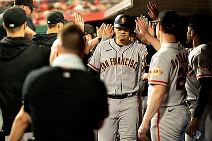 San Francisco Giants first baseman Wilmer Flores (41) celebrates with teammates after hitting a game tying 3-run home run in the third inning of the MLB baseball game between the Cincinnati Reds and San Francisco Giants at Great American Ball Park in Cincinnati on Tuesday, July 18, 2023.