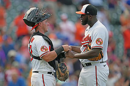 Jul 19, 2023; Baltimore, Maryland, USA; Baltimore Orioles pitcher Felix Bautista (right) greets catcher James McCann (left) after earning a save against the Los Angeles Dodgers at Oriole Park at Camden Yards. Mandatory Credit: Mitch Stringer-USA TODAY Sports