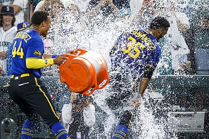 Jul 21, 2023; Seattle, Washington, USA; Seattle Mariners designated hitter Teoscar Hernandez (35) receives a water-bucket dunking from center fielder Julio Rodriguez (44) after hitting a walk-off RBI-single against the Toronto Blue Jays during the ninth inning at T-Mobile Park. Mandatory Credit: Joe Nicholson-USA TODAY Sports