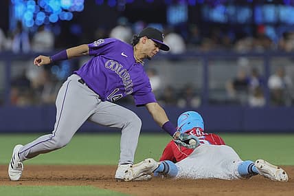 Jul 22, 2023; Miami, Florida, USA; Miami Marlins left fielder Jon Berti (5) steals second base against Colorado Rockies shortstop Ezequiel Tovar (14) during the seventh inning at loanDepot Park. Mandatory Credit: Sam Navarro-USA TODAY Sports