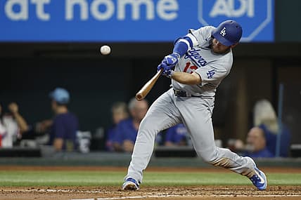 Jul 22, 2023; Arlington, Texas, USA; Los Angeles Dodgers third baseman Max Muncy (13) hits a home run against the Texas Rangers in the third inning at Globe Life Field. Mandatory Credit: Tim Heitman-USA TODAY Sports