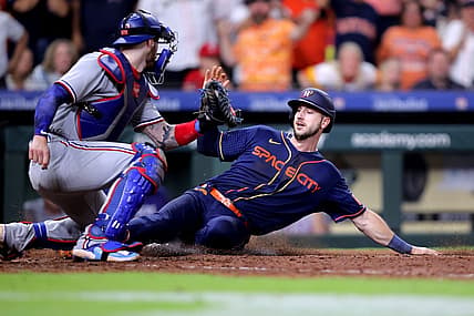 Jul 24, 2023; Houston, Texas, USA; Houston Astros right fielder Kyle Tucker (30) slides into home plate to score the game winning run while beating the tag of Texas Rangers catcher Jonah Heim (28) during the ninth inning at Minute Maid Park. Mandatory Credit: Erik Williams-USA TODAY Sports
