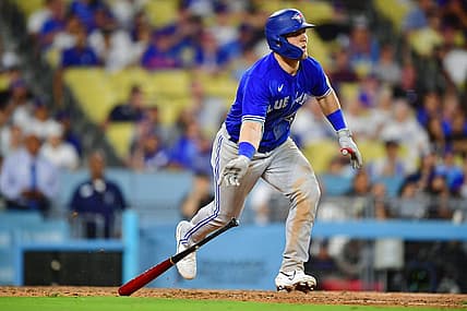 Jul 24, 2023; Los Angeles, California, USA; Toronto Blue Jays left fielder Daulton Varsho (25) hits a two run RBI double against the Los Angeles Dodgers during the eleventh inning  at Dodger Stadium. Mandatory Credit: Gary A. Vasquez-USA TODAY Sports