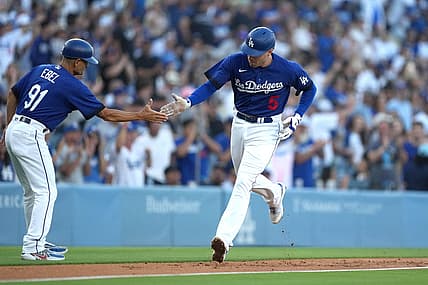 Jul 25, 2023; Los Angeles, California, USA; Los Angeles Dodgers first baseman Freddie Freeman (5) is congratulated by third base coach Dino Ebel (91) after hitting a solo home run in the first inning against the Toronto Blue Jays at Dodger Stadium. Mandatory Credit: Kirby Lee-USA TODAY Sports
