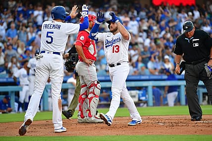 Jul 29, 2023; Los Angeles, California, USA; Los Angeles Dodgers third baseman Max Muncy (13) is greeted by first baseman Freddie Freeman (5) after hitting a two run home run against the Cincinnati Reds during the first inning at Dodger Stadium. Mandatory Credit: Gary A. Vasquez-USA TODAY Sports