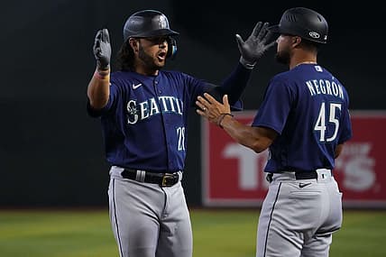 Jul 30, 2023; Phoenix, Arizona, USA; Seattle Mariners third baseman Eugenio Suarez (28) celebrates with Seattle Mariners first base coach Kristopher Negr  n (45) after hitting an RBI single against the Arizona Diamondbacks during the ninth inning at Chase Field. Mandatory Credit: Joe Camporeale-USA TODAY Sports