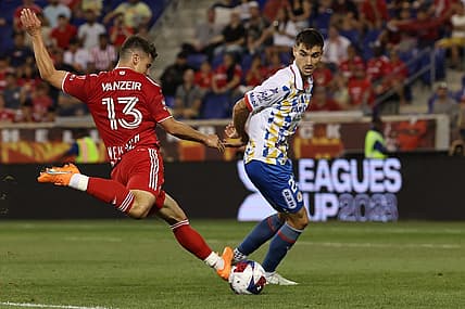 Jul 30, 2023; Harrison, NJ, USA; New York Red Bulls forward Dante Vanzeir (13) shoots the ball in front of Atletico De San Luis defender Pablo Martinez (28) during the second half at Red Bull Arena. Mandatory Credit: Vincent Carchietta-USA TODAY Sports