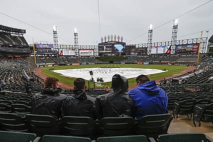 Jun 25, 2022; Chicago, Illinois, USA; Fans wait for a start of a baseball game between the Baltimore Orioles and the Chicago White Sox as tarp covers the infield during a rain delay at Guaranteed Rate Field. Mandatory Credit: Kamil Krzaczynski-USA TODAY Sports