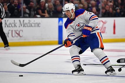 Apr 23, 2023; Los Angeles, California, USA; Edmonton Oilers defenseman Evan Bouchard (2) moves the puck against the Los Angeles Kings during the third period in game four of the first round of the 2023 Stanley Cup Playoffs at Crypto.com Arena. Mandatory Credit: Gary A. Vasquez-USA TODAY Sports
