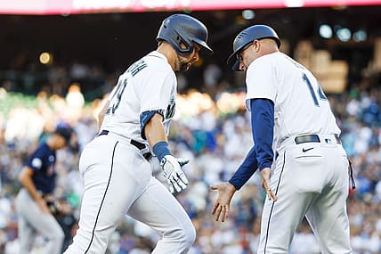 Jul 31, 2023; Seattle, Washington, USA; Seattle Mariners catcher Cal Raleigh (29) receives a greeting from third base coach Manny Acta (14) while running the bases following a solo-home run against the Boston Red Sox during the second inning at T-Mobile Park. Mandatory Credit: Joe Nicholson-USA TODAY Sports
