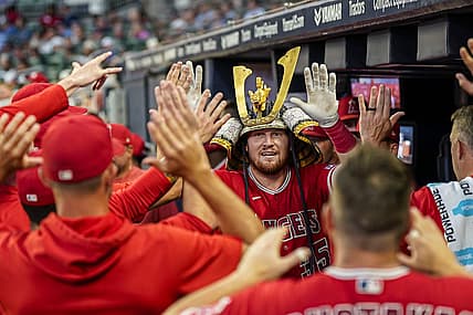Jul 31, 2023; Cumberland, Georgia, USA; Los Angeles Angels catcher Chad Wallach (35) reacts with teammates in the dugout after hitting a home run against the Atlanta Braves during the sixth inning at Truist Park. Mandatory Credit: Dale Zanine-USA TODAY Sports