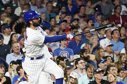 Aug 1, 2023; Chicago, Illinois, USA; Chicago Cubs shortstop Dansby Swanson (7) hits a two-run homer against the Cincinnati Reds during the fourth inning at Wrigley Field. Mandatory Credit: David Banks-USA TODAY Sports