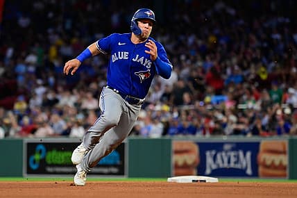 Aug 4, 2023; Boston, Massachusetts, USA; Toronto Blue Jays center fielder Daulton Varsho (25) scores on an RBI by right fielder George Springer (4) during the fourth inning against the Boston Red Sox at Fenway Park. Mandatory Credit: Eric Canha-USA TODAY Sports