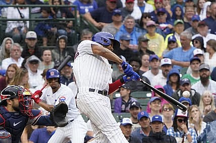 Aug 6, 2023; Chicago, Illinois, USA; Chicago Cubs first baseman Jeimer Candelario (9) hits a one run single against the Atlanta Braves during the fifth inning at Wrigley Field. Mandatory Credit: David Banks-USA TODAY Sports
