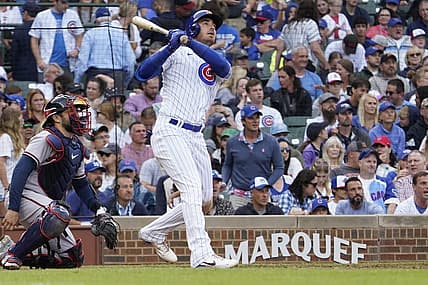 Aug 6, 2023; Chicago, Illinois, USA; Chicago Cubs center fielder Cody Bellinger (24) hits a single against the Atlanta Braves during the seventh inning at Wrigley Field. Mandatory Credit: David Banks-USA TODAY Sports