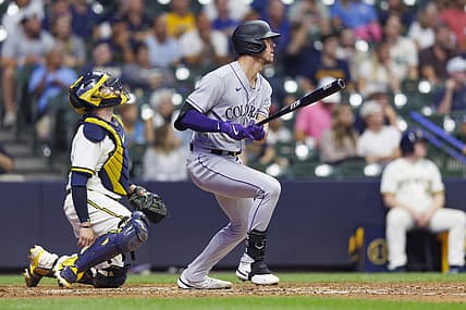 Aug 8, 2023; Milwaukee, Wisconsin, USA;  Colorado Rockies left fielder Nolan Jones (22) hits a sacrifice fly ball during the tenth inning against the Milwaukee Brewers at American Family Field. Mandatory Credit: Jeff Hanisch-USA TODAY Sports