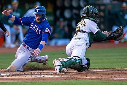 Aug 8, 2023; Oakland, California, USA;  Texas Rangers catcher Sam Huff (55) scores on a single hit by Texas Rangers second baseman Marcus Semien (not pictured) against the Oakland Athletics during the fourth inning at Oakland-Alameda County Coliseum. Mandatory Credit: Neville E. Guard-USA TODAY Sports