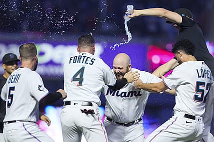 Aug 13, 2023; Miami, Florida, USA; Miami Marlins third baseman Jake Burger (36) celebrates with catcher Nick Fortes (4), relief pitcher Jorge Lopez (52), and shortstop Jon Berti (5) after hitting a walk-off single against the New York Yankees at loanDepot Park. Mandatory Credit: Sam Navarro-USA TODAY Sports