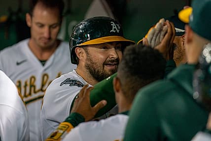 Aug 21, 2023; Oakland, California, USA;  Oakland Athletics catcher Shea Langeliers (23) celebrates with teammates in the dugout after hitting a solo homer against the Kansas City Royals during the sixth inning at Oakland-Alameda County Coliseum. Mandatory Credit: Neville E. Guard-USA TODAY Sports