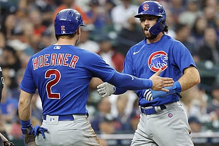Aug 23, 2023; Detroit, Michigan, USA;  Chicago Cubs second baseman Nico Hoerner (2) and shortstop Dansby Swanson (7) congratulate each other after scoring in the third inning against the Detroit Tigers at Comerica Park. Mandatory Credit: Rick Osentoski-USA TODAY Sports