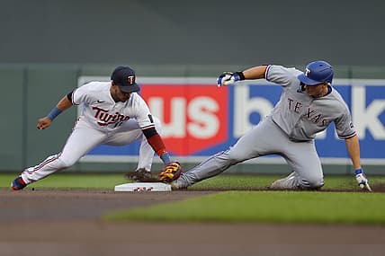 Aug 25, 2023; Minneapolis, Minnesota, USA; Texas Rangers shortstop Corey Seager (5) beats the tag of Minnesota Twins second baseman Jorge Polanco (11) for a double in the first inning at Target Field. Mandatory Credit: Bruce Kluckhohn-USA TODAY Sports