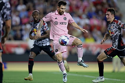 Aug 26, 2023; Harrison, New Jersey, USA; Inter Miami CF forward Lionel Messi (10) controls the ball against New York Red Bulls defender Andres Reyes (4) and midfielder Peter Stroud (5) during the second half at Red Bull Arena. Mandatory Credit: Brad Penner-USA TODAY Sports