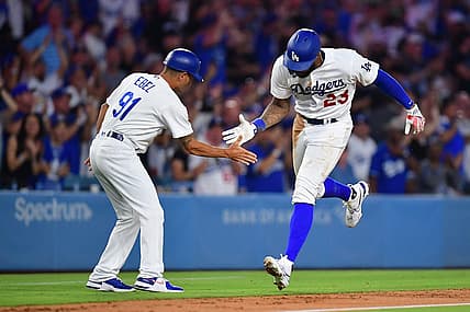 Aug 28, 2023; Los Angeles, California, USA; Los Angeles Dodgers right fielder Jason Heyward (23) is greeted by third base coach Dino Ebel (91) after hitting a two run home run against the Arizona Diamondbacks during the sixth inning at Dodger Stadium. Mandatory Credit: Gary A. Vasquez-USA TODAY Sports