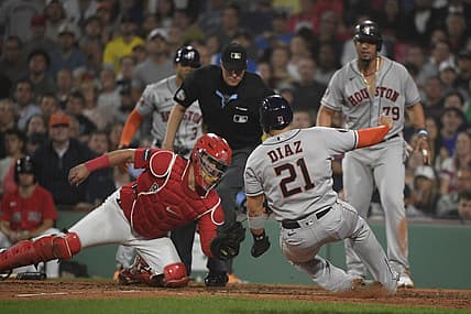 Aug 29, 2023; Boston, Massachusetts, USA;  Houston Astros catcher Yainer Diaz (21) slides safely into home plate before the tag of Boston Red Sox catcher Reese McGuire (3) during the sixth inning at Fenway Park. Mandatory Credit: Bob DeChiara-USA TODAY Sports