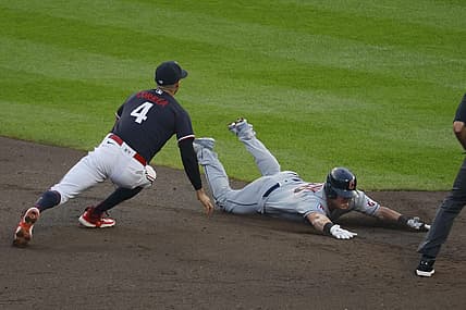 Aug 29, 2023; Minneapolis, Minnesota, USA; Cleveland Guardians first baseman Kole Calhoun (26) slides into second base for a double before Minnesota Twins shortstop Carlos Correa (4) can tag him in the third inning at Target Field. Mandatory Credit: Bruce Kluckhohn-USA TODAY Sports