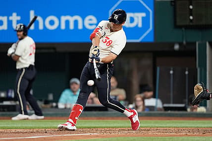Sep 9, 2023; Arlington, Texas, USA; Texas Rangers first baseman Nathaniel Lowe (30) hits an RBI single against the Oakland Athletics during the sixth inning at Globe Life Field. Mandatory Credit: Jim Cowsert-USA TODAY Sports