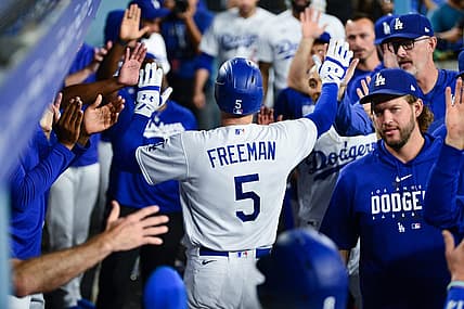 Sep 12, 2023; Los Angeles, California, USA; Los Angeles Dodgers first baseman Freddie Freeman (5) is greeted after hitting a two run home run against the San Diego Padres during the third inning at Dodger Stadium. Mandatory Credit: Gary A. Vasquez-USA TODAY Sports