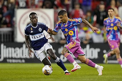 Sep 16, 2023; Toronto, Ontario, CAN; Toronto FC forward Lorenzo Insigne (24) moves the ball against Vancouver Whitecaps defender Richie Laryea (7) during the first half at BMO Field. Mandatory Credit: Kevin Sousa-USA TODAY Sports