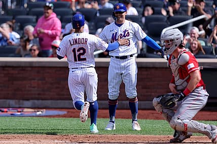 Sep 17, 2023; New York City, New York, USA; New York Mets shortstop Francisco Lindor (12) and designated hitter Brandon Nimmo (9) celebrate after scoring on a double by catcher Francisco Alvarez (not pictured) during the third inning against the Cincinnati Reds at Citi Field. Mandatory Credit: Brad Penner-USA TODAY Sports