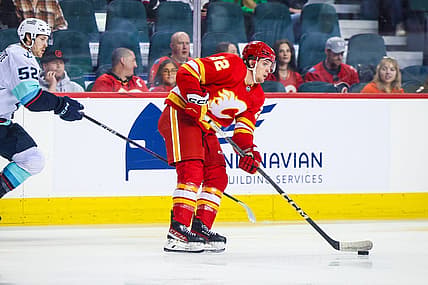 Sep 25, 2023; Calgary, Alberta, CAN; Calgary Flames left wing Jakob Pelletier (22) controls the puck against the Seattle Kraken during the first period at Scotiabank Saddledome. Mandatory Credit: Sergei Belski-USA TODAY Sports