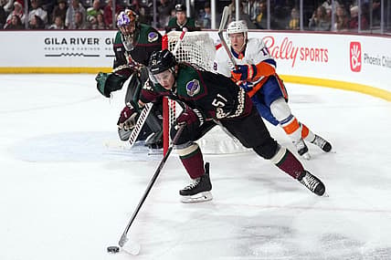 Dec 16, 2022; Tempe, Arizona, USA; Arizona Coyotes defenseman Troy Stecher (51) skates by New York Islanders left wing Anthony Beauvillier (18) during the first period at Mullett Arena. Mandatory Credit: Joe Camporeale-USA TODAY Sports