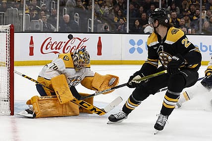 Mar 28, 2023; Boston, Massachusetts, USA; Boston Bruins defenseman Brandon Carlo (25) watches as his shot goes over the head of Nashville Predators goaltender Juuse Saros (74) during the first period at TD Garden. Mandatory Credit: Winslow Townson-USA TODAY Sports