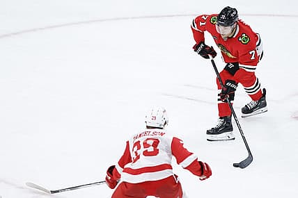Oct 3, 2023; Chicago, Illinois, USA; Chicago Blackhawks forward Taylor Hall (71) passes the puck against Detroit Red Wings forward Nate Danielson (29) during the third period of a preseason hockey game at United Center. Mandatory Credit: Kamil Krzaczynski-USA TODAY Sports