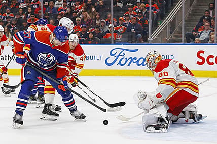 Oct 4, 2023; Edmonton, Alberta, CAN; Edmonton Oilers forward Warren Foegele (37) tries to get a shot away on Calgary Flames goaltender Dan Vladar (80) during the third period at Rogers Place. Mandatory Credit: Perry Nelson-USA TODAY Sports