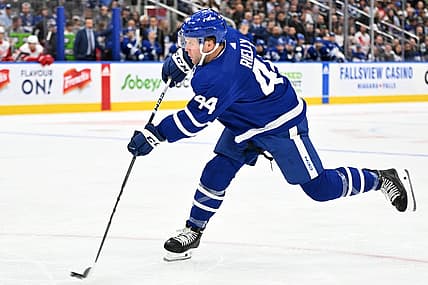 Oct 5, 2023; Toronto, Ontario, CAN; Toronto Maple Leafs defenseman Morgan Rielly (44) shoots the puck against the Detroit Red Wings in the first period at Scotiabank Arena. Mandatory Credit: Dan Hamilton-USA TODAY Sports