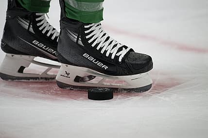 Oct 5, 2023; Dallas, Texas, USA; A view of the game puck and the face-off circle and hockey skates during the game between the Dallas Stars and the St. Louis Blues at the American Airlines Center. Mandatory Credit: Jerome Miron-USA TODAY Sports