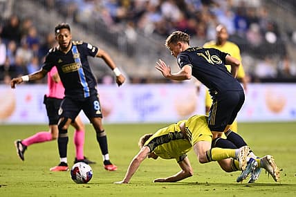 Oct 7, 2023; Philadelphia, Pennsylvania, USA; Philadelphia Union midfielder Jack McGlynn (16) and Nashville SC midfielder Dax McCarty (6) battle for position in the first half at Subaru Park. Mandatory Credit: Kyle Ross-USA TODAY Sports