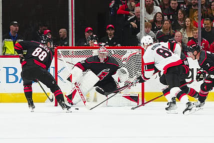 Oct 11, 2023; Raleigh, North Carolina, USA; Carolina Hurricanes goaltender Frederik Andersen (31) center Martin Necas (88) and Ottawa Senators left wing Dominik Kubalik (81) watch the puck during the first period at PNC Arena. Mandatory Credit: James Guillory-USA TODAY Sports